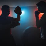 Silhouettes of men fighting in boxing