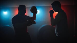 Silhouettes of men fighting in boxing