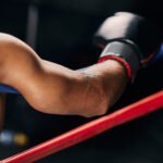 Sports, fight and hand of a boxing man resting in the corner of a boxing ring during an exhibition